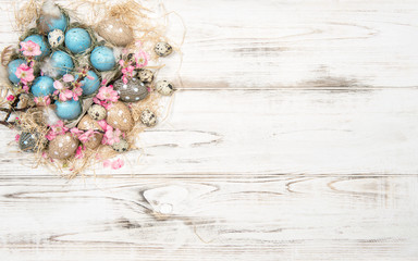 Easter decoration with blue eggs and pink flowers