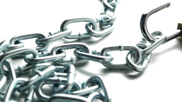 Closeup on silver chain on metal finish background.