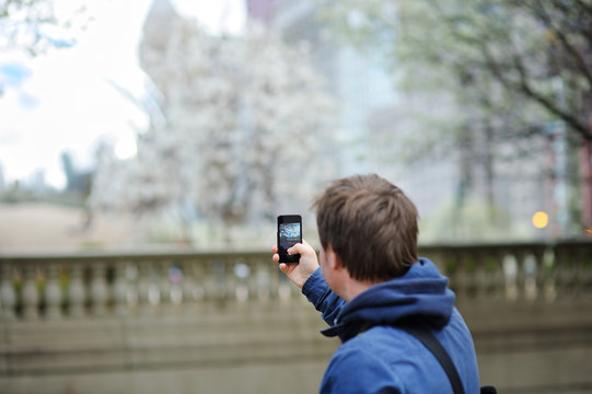 Male tourist taking mobile photo using his phone