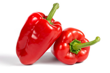 Two ripe red sweet peppers isolated on a white background