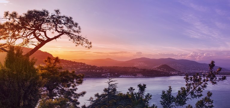 Panoramic view over a coastal town at sunset