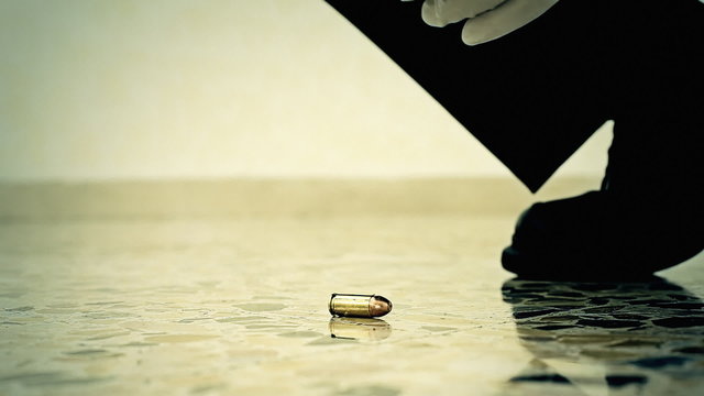 Crime scene CSI collecting bullet CU