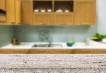 Empty wooden table and blurred kitchen background