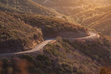 Windy curvy roads through the mountains on a sunset