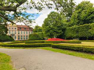 view on abbots palace and flowers in gdansk oliva park.