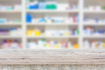 wood counter with blur shelves of drugs in the pharmacy