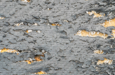 Closeup old and peeling black motorcycle seat texture background