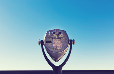 Coin-operated viewer against the blue sky