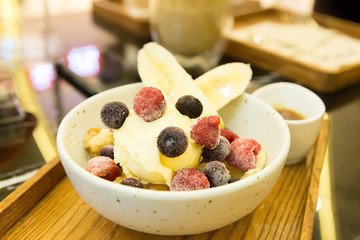 vanilla ice-cream and berry in white plate