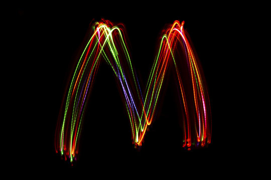 Word writing from light on the black background. - Powered by Adobe