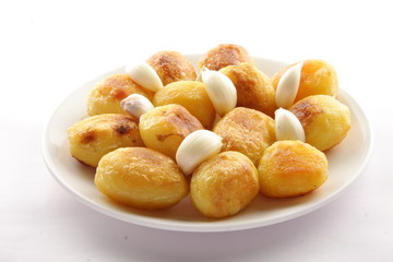 Crispy baked potatoes with garlic,Selective focus .