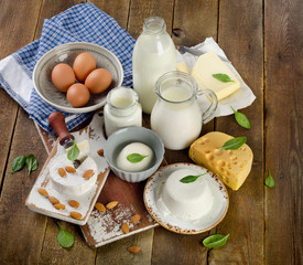 Tasty healthy dairy products on rustic wooden table.