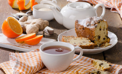 Cup of hot tea with ginger and orange.