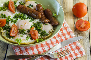 Breakfast - scrambled eggs with tomatoes and greens