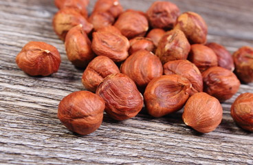 Heap of brown hazelnut on wooden table