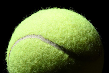 Tennis ball isolated on black background