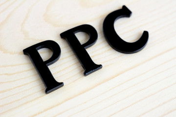 PPC (or Pay Per Click) sign on wood background