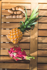 Tropical Fruits on Wooden Background