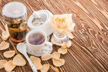 Tea cups with teapot on old wooden table
