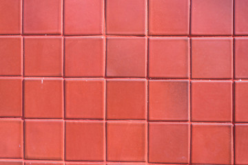 A wall of red tile aging by time and faded by weather. A fine work and background for house design
