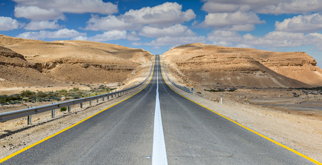 Desert road among stone hills