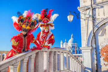 Beautiful carnival masks against Salute cathedral in Venice, Italy