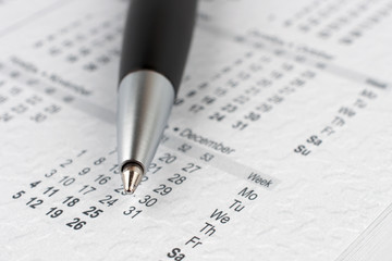 Black ballpoint pen on a calendar