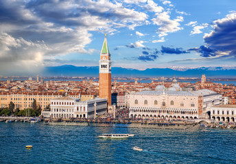 Naklejka premium Piazza San Marco with Bell Tower and the Doge Palace against Italian Alps in Venice, Italy