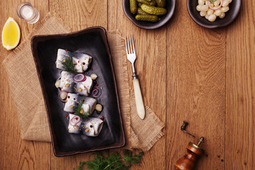 Rolled herring in vinegar, served with onions and pickles.