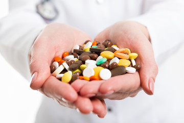 Pills in hands of doctor. Photo closeup.