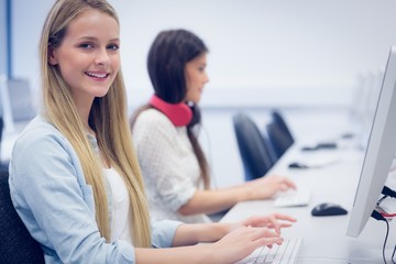 Smiling students using computer 