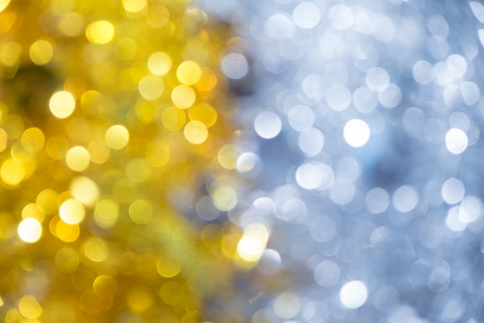 Gold half silver glitter sparkle defocused rays lights bokeh abstract chistmas background.