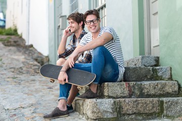Hip men sitting on steps