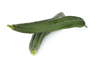 whole Fresh Angled luffa on white background