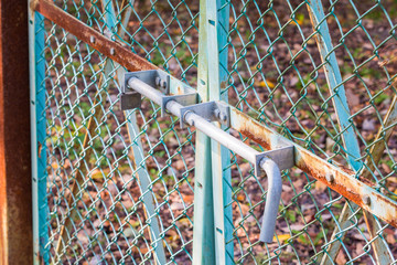 Old fence locked metal door.