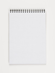 Top view of a notepad. Single object isolated on white background. Concept photograph with copy space. Writing or noting accessories theme.