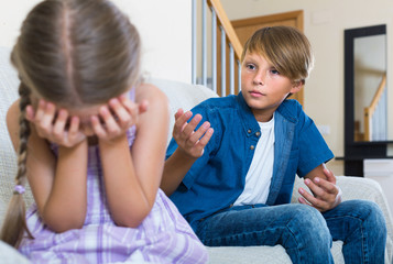 Teenage boy and  little girl quarrelling at home