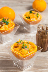 delicious appetizer with orange and anchovy fillet inside  half