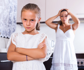 Unhappy girl and mother arguing