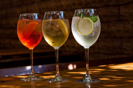 Cocktails: aperol spritz, sprizz (spriss), Martini royale. (dark background). Sparkling wine. Champagne.