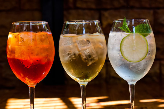 Cocktails: Aperol Spritz, Sprizz (spriss), Martini Royale. (dark Background). Sparkling Wine. Champagne.