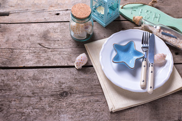 Nautical table setting on aged  wooden background.