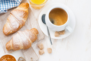 traditional breakfast with fresh croissants on white 