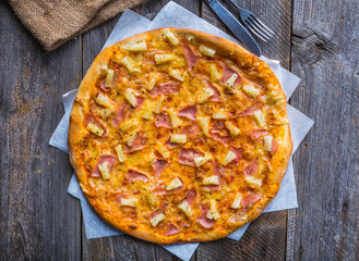 Hawaiian Pizza on a wooden table