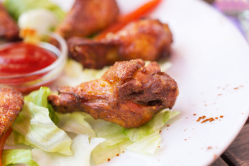 Grilled chicken wings with spicy ketchup.