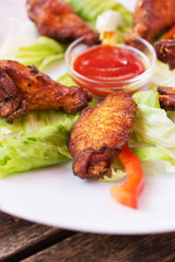 Grilled chicken wings with spicy ketchup.