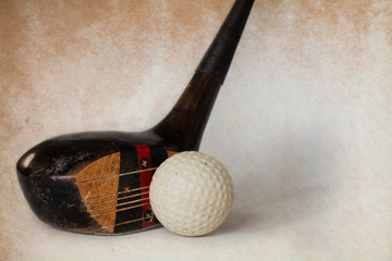 Vintage, antique golf driver (putter). golf club. retro paper background.