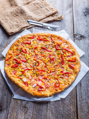 Delicious pizza with peppers, corn and peas