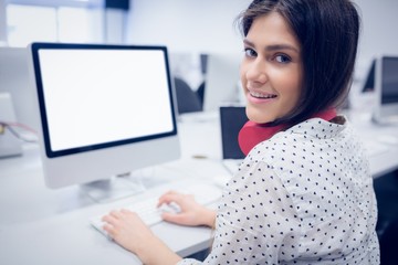 Smiling student working on computer 