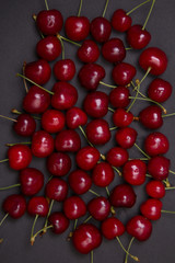 Tasty fresh cherries on black background